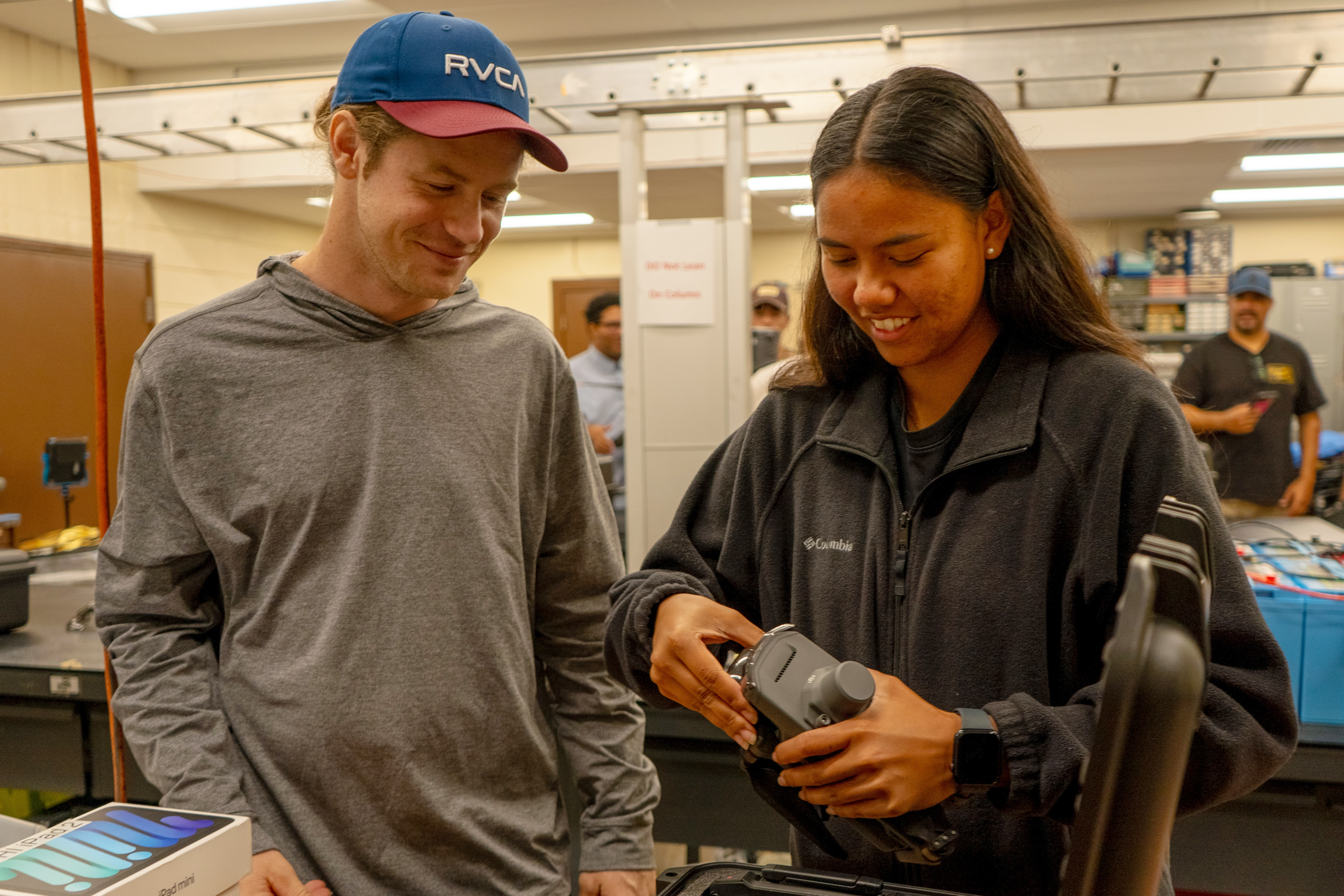 ENGT 107 students Avery Bryce and Tiala-Ann Kailianu-Carvalho inspect the Mavic 3 Multi- spectral drone for flight.