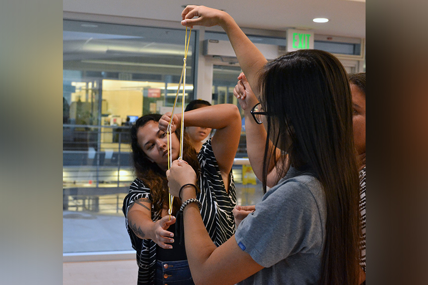 people creating string figures