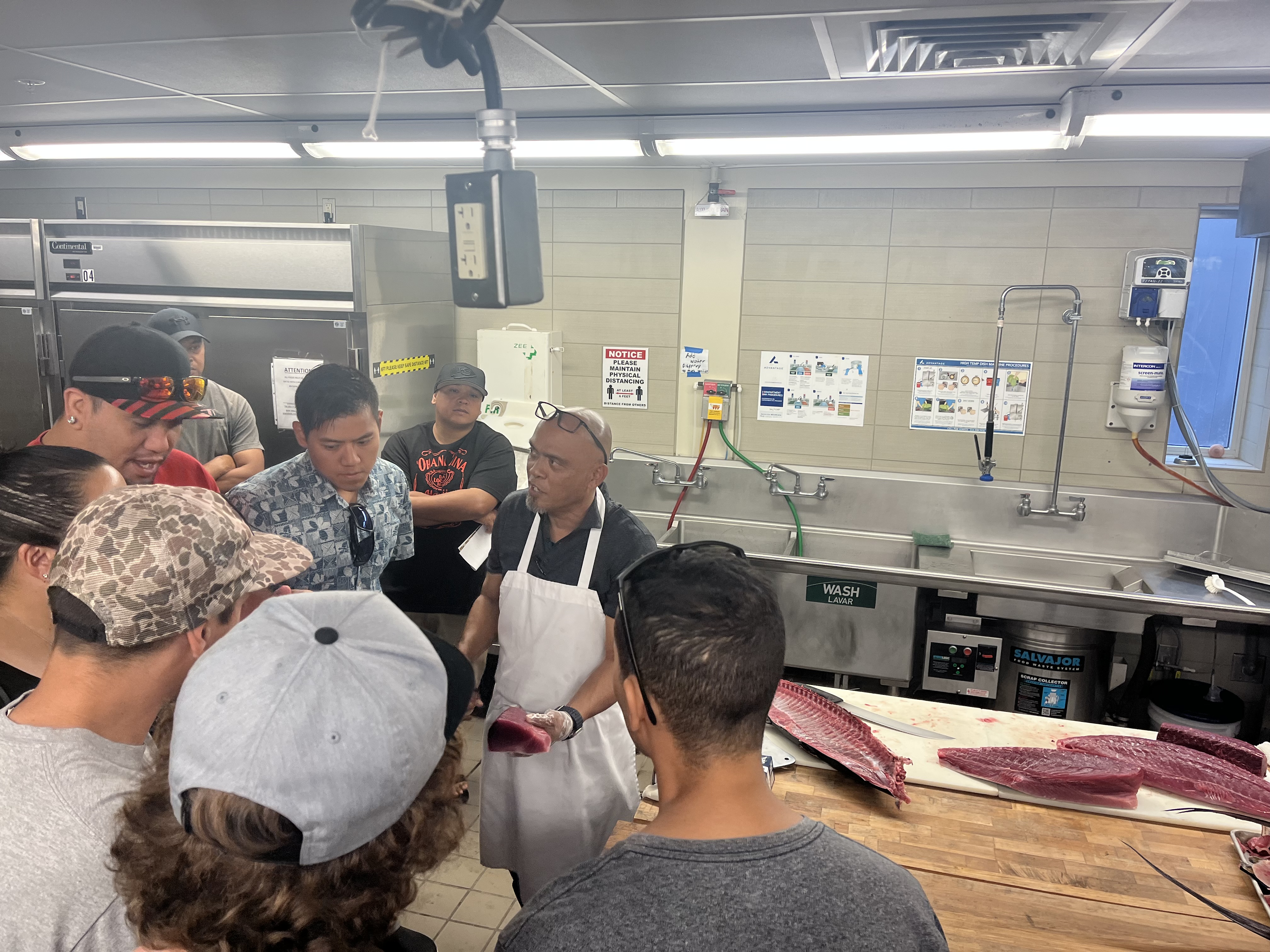 Nelson Aberilla shows a piece of ahi to workshop attendees. 