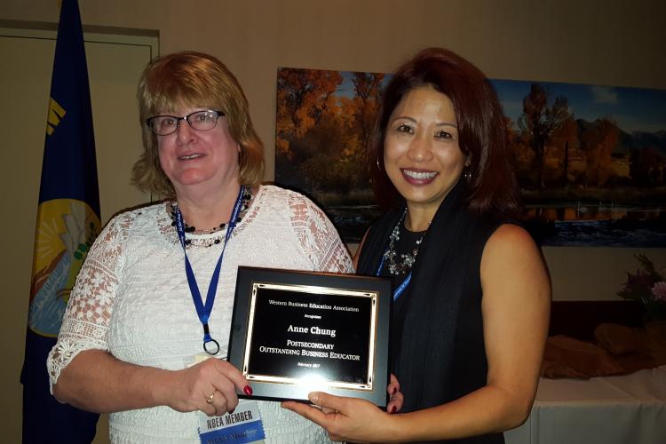 Anne Chung, right, receiving her award at the WBEA conference in Bozeman. Presenting the award is Elaine Stedman, WBEA President.