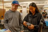 ENGT 107 students Avery Bryce and Tiala-Ann Kailianu-Carvalho inspect the Mavic 3 Multi- spectral drone for flight.