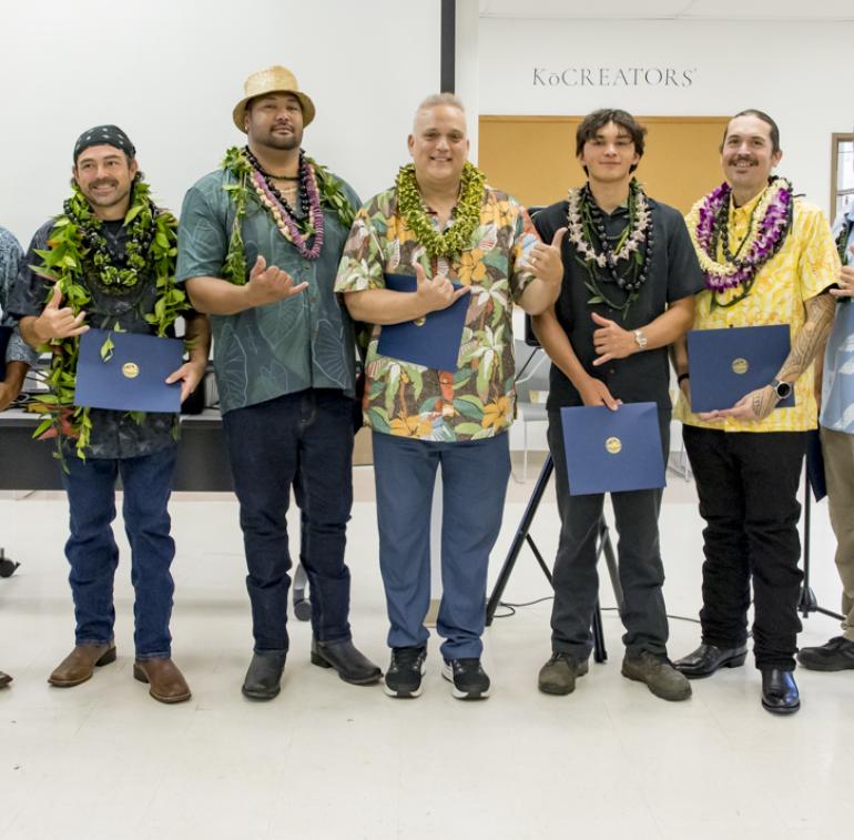 The inaugural class of Hawai‘i Community College’s butchery course with instructor Bill Wong (third from left) and Wade Cypriano (far right), Hawaii CC Chancellor Susan Kazama (far left), Hawaii CC VCAA Kimberley Collins (second from left), and Mayor Kimo Alameda (center). (Photo Credit: Sarah Anderson)